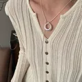 Adjustable silver-plated lariat necklace with circular pendant on ivory knitted sweater - Silver Brushed Circle Style