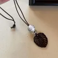 Minimalist brown monstera leaf pendant necklace with zebra bead for long sweater chain - Monstera Leaf Hollow Necklace