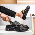 Men's stylish black beach clogs featuring thick soles and vibrant orange buckle accents - 38 / Black Orange Floral