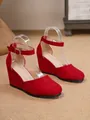 Elegant red suede wedge sandals featuring a comfortable ankle strap and classic rounded toe - 34 / Red