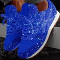 Close-up of vibrant blue sequined sneakers with dazzling rhinestone accents and chunky soles. - 35 / Blue