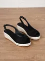 Detail shot of black peep-toe wedge sandals with braided jute soles and ankle straps. - 34 / Black