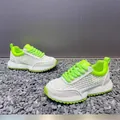 Detailed view of white mesh sneakers with neon green accents and thick soles - 40 / White Green