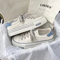 Stylish women's platform white canvas shoes with blue accents and thick woven laces - 35 / Blue