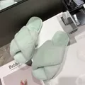 Close-up detail of mint green cross-band faux fur slippers on a clean bathroom counter - 38 / Mint Green
