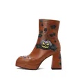Close-up detail of brown platform ankle boot with Halloween pumpkin and vine print - 40 / Tan