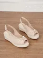 Stylish beige peep-toe wedge espadrilles featuring rope-wrapped platform and knot detail. - 34 / Apricot