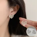 Elegant silver-toned heart-shaped earrings with delicate filigree pattern for women - Vintage Lace Heart (ED2578) / 1 Pair
