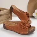 Detail view of brown platform wedge sandals with large leather flower ornament and peep toe - Tan