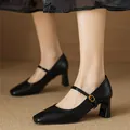 Close-up of black vintage square-toe Mary Jane block heel pumps with ankle strap. - Black