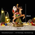 Statuetta decorativa natalizia in resina Babbo Natale su renna per la casa, 34 cm altezza - Babbo Natale su cavallo a dondolo (con luce) (RRW125-A) / Rosso bianco