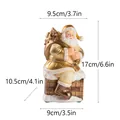 Statuetta di Babbo Natale in resina dorata su camino con dimensioni dettagliate di 17 cm - Babbo Natale Seduto sul Camino con Regali (RRW121-GD) / Oro