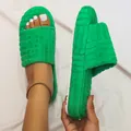 Detailed view of green embossed plush one-band slippers featuring a thick comfortable white sole - 35 / Green