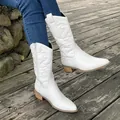 Close-up of women's white pointed toe cowboy boots with elegant embroidery on wood deck - 36 / White