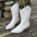 Elegant white mid-calf cowboy boots featuring western embroidery, pointed toe and block heel - White