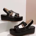 Close-up of elegant black Roman platform sandals with adjustable buckle straps for women - 36 / Black