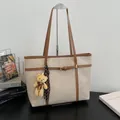 Elegant cream faux leather tote bag with brown trim and cute bear charm accessory - With Pendant / Off White