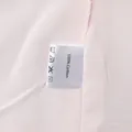 Detailed close-up view of the care label confirming 100% cotton material on pink vest - S / Top And Bottom / Pink