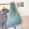Stylish light blue faux fur tote bag with long shaggy tassels and large capacity. - Teal