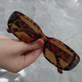 Close-up detail of retro tortoiseshell rectangular sunglasses with tinted brown lenses - Leopard Frame / Tea Lens