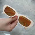 Small rectangular sunglasses with cream frame and orange lenses for trendy fashion styling. - Milk Tea Frame Tea Lens