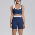 Two-piece navy blue ribbed yoga set with white contrast trim and high-waist shorts - S / Top And Bottom / Badge Blue