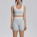 Detail view of a grey and white color-block high-waist yoga sports bra and shorts set - S / Top And Bottom / Clay Grey