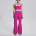 Detail view of pink contrast color yoga set featuring flared sports pants and top - S / Top And Bottom / Dragon Fruit