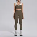 Close-up front view of a two-piece olive green yoga set with white contrast trim - S / Top And Bottom / Coffee