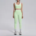 Detailed front view of a mint green yoga set with white contrast trim on a fitness model - S / Top And Bottom / Mint Green