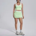 Full body shot of a model in mint green and white colorblock yoga set with high waist skirt - S / Top And Bottom / Mint Green