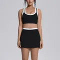 Black and white colorblock yoga set featuring a sports bra and high-waist skirt - S / Top And Bottom / Premium Black
