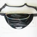 Close-up of black shiny waist bag with iridescent rainbow zipper detail for women. - Black PU