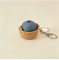 Detailed view of 3D printed blueberry button toy keychain in a tiny woven basket - Blueberry Charm / Keychain style