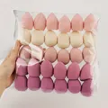 Set of 25 teardrop makeup sponges in assorted pink and beige tones for cosmetic use - 30Pcs Pack / Pink Series