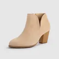 Close-up detail of beige suede ankle boot featuring a chunky heel and side V-cutout design - US11 / Apricot