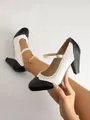 Close-up of two-tone black and white Mary Jane heels with elegant brogue detailing - 36 / Black and White Patchwork