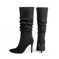 Close-up detail of black pointed-toe stiletto boots with trendy slouchy pleated design - US7 / Black