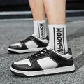 Stylish black and white leather casual board sneakers with lace-up design for unisex. - 38 / Black and White