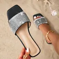 Women's black square toe flat sandals with shimmering rhinestone strap on a sandy beach - 36 / Black