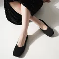 Close-up of black square-toe fly-knit flats on model with sequin dress - 6 / Black