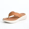Detail view of women's brown platform flip flops featuring a comfortable massage footbed - EU 36 / Brown