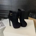 Close-up detail of sexy black suede ankle boots with 16cm high heels and gold buckle - 35 / Black