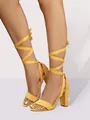Close-up view of vibrant yellow suede high heel sandals featuring cross-tie ankle straps - 5 / Yellow