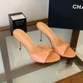 Elegant peach patent leather high-heeled mules with open toe design and stiletto heel - Apricot