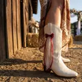 Red ribbon and pearl charm accessory for western cowboy boots SKU variant lifestyle photo - Red