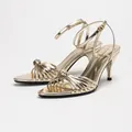 Elegant gold mirror-finish pointed toe sandals with ankle strap and knot detail - 38 / Gold Mirror Bracelet