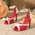Detailed view of red and white high heel sandals with bow and ankle strap - 35 / Red