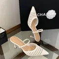 Detailed view of the intricate white woven texture on pointed toe stiletto mules - 35 / White