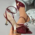 Close-up of wine red sequined Latin dance heels with bow detail and stylish gold heel - 36 / Burgundy